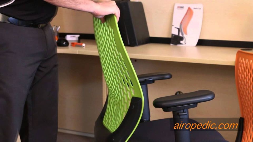 A chiropractor flexing the BackUup backrest to demonstrate its movement